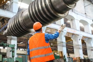 worker standing below a pipe